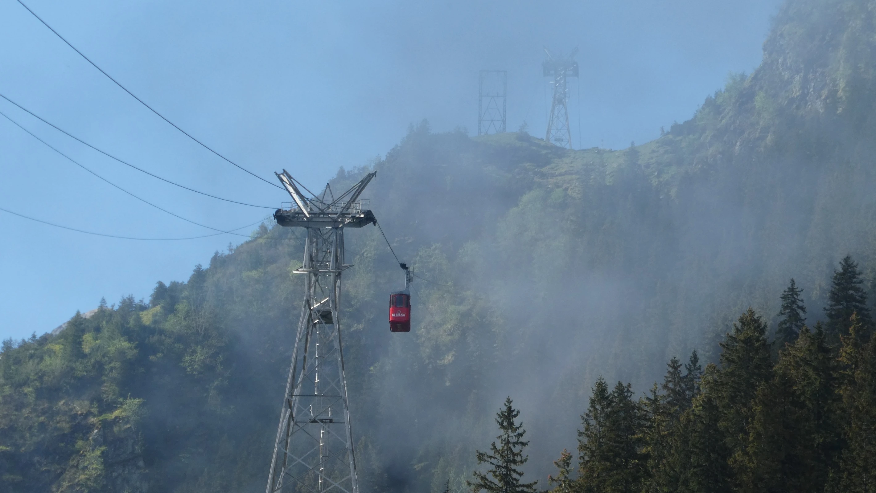 A misty view of the cable cars over Cascada Balea